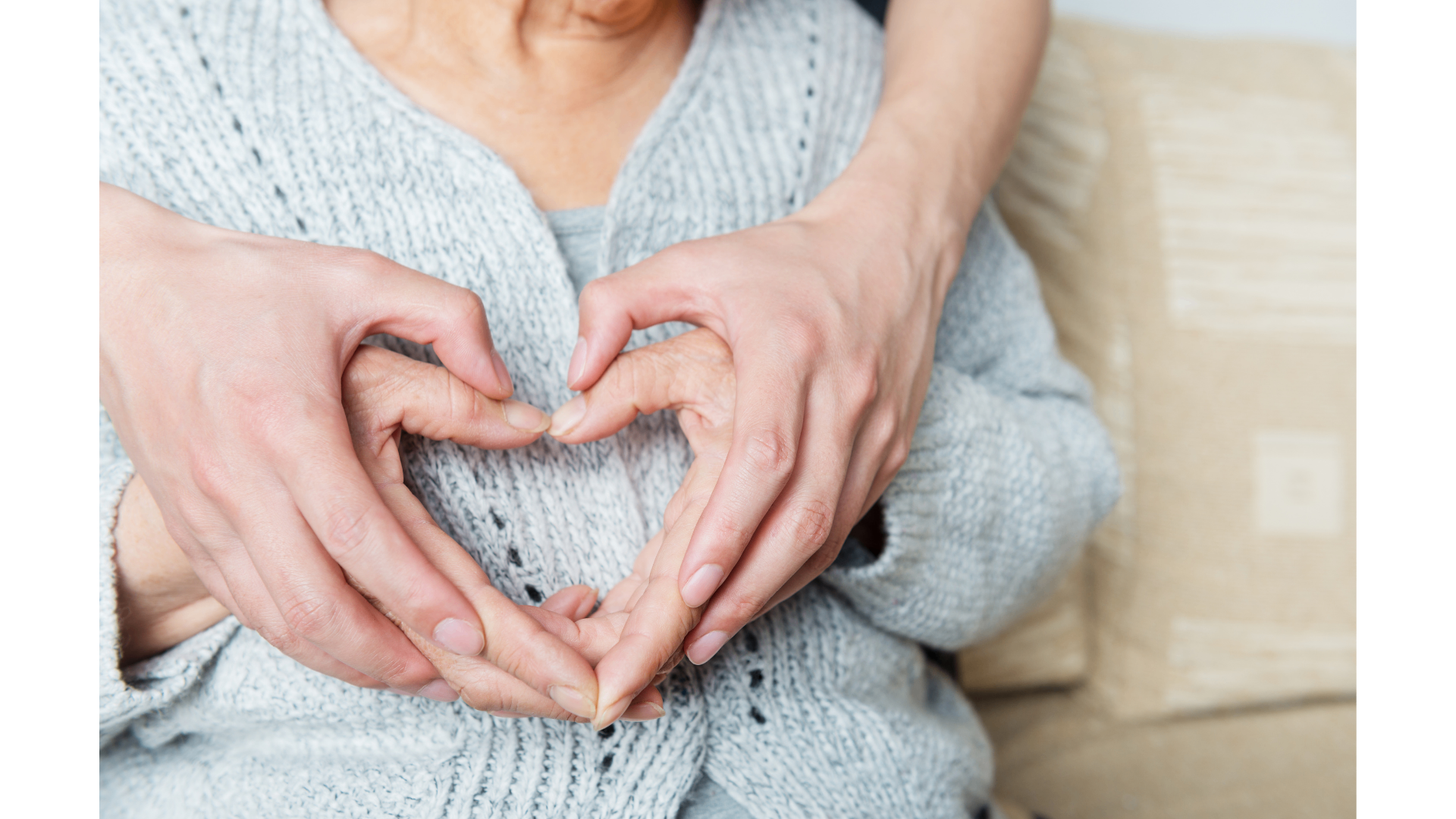 Two generations of hands forming a heart — clarity as an act of love